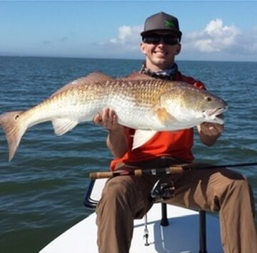 Angler holding a large redfish