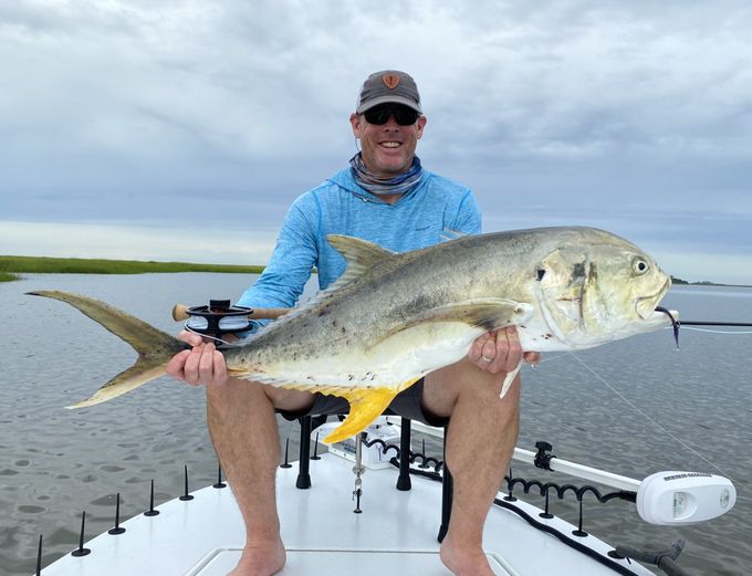 Angler with a jack crevalle on the skiff