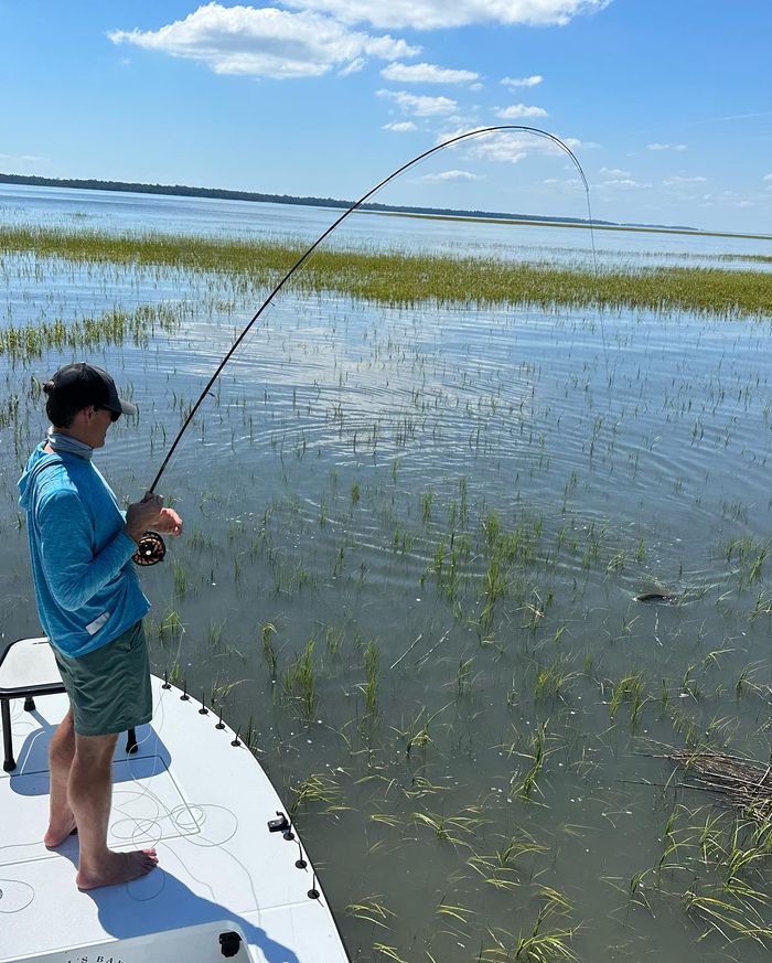 Young angler casting a fly rod over the flats