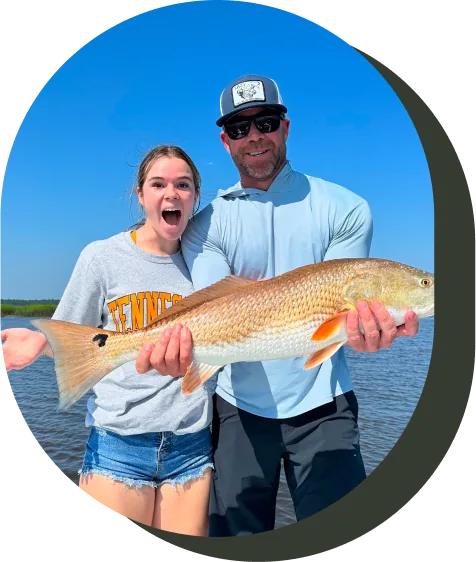 Captain Scott Dykes with a young angler and her redfish